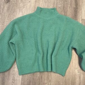 Anna Grace large teal sweater with slightly domed sleeves.